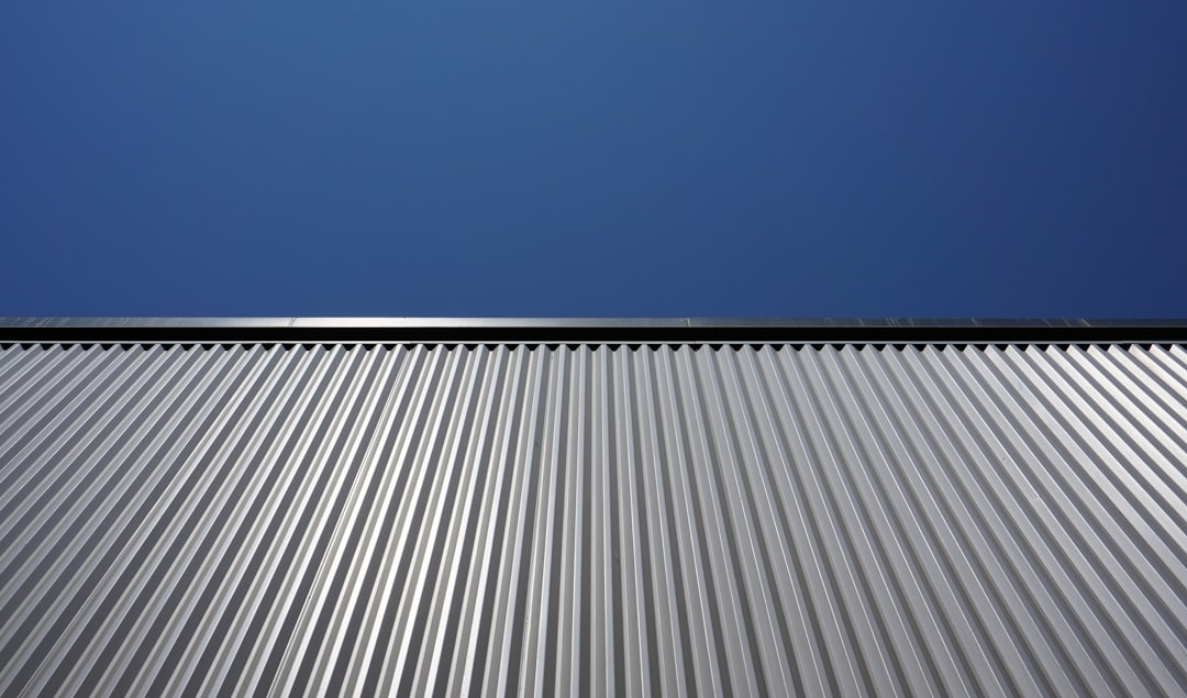 Close-up of a corrugated metal roof against a clear blue sky