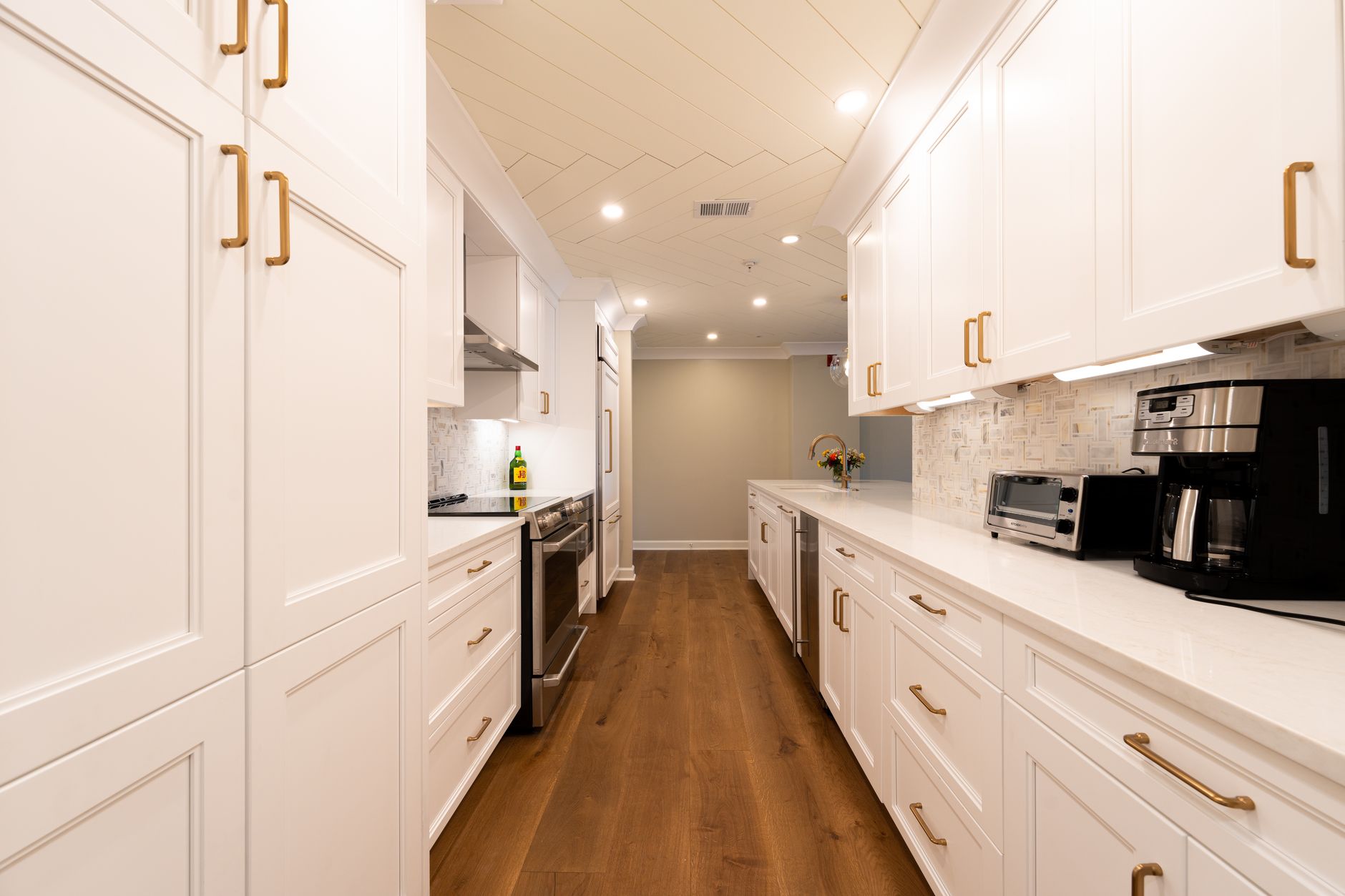 Modern kitchen with white cabinets and stainless steel appliances